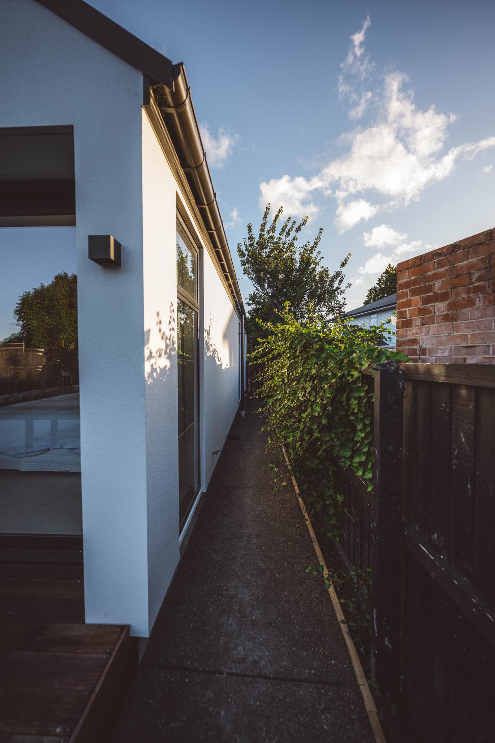 An exposed-aggregate path running down the side of the house.