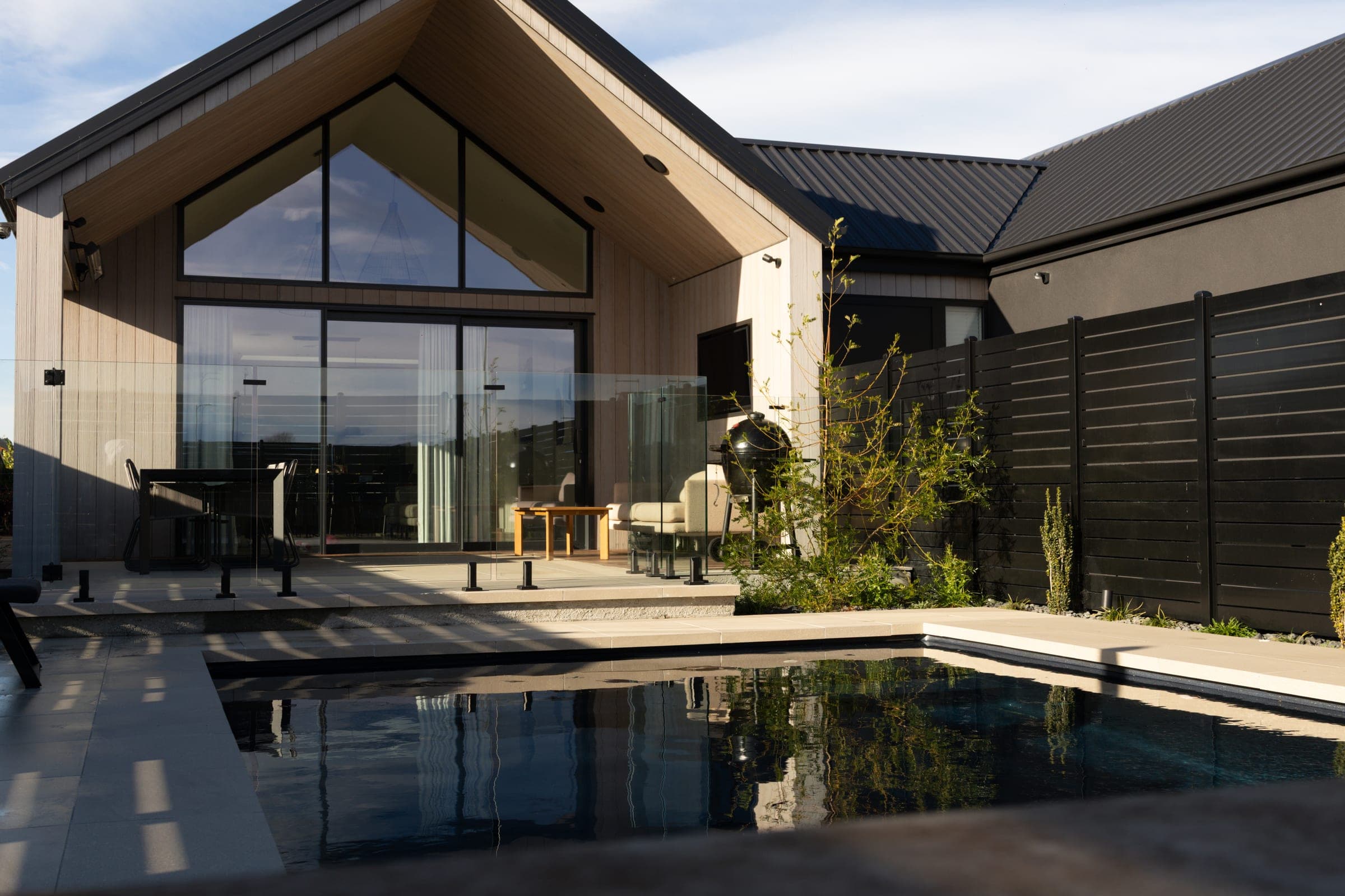 Frameless glass pool fencing keeps the sightlines open across the courtyard.